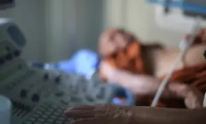 Badanie echo serca z dopplerem. Lekarz wykonuje USG pacjentowi, skupiając się na obrazie serca.